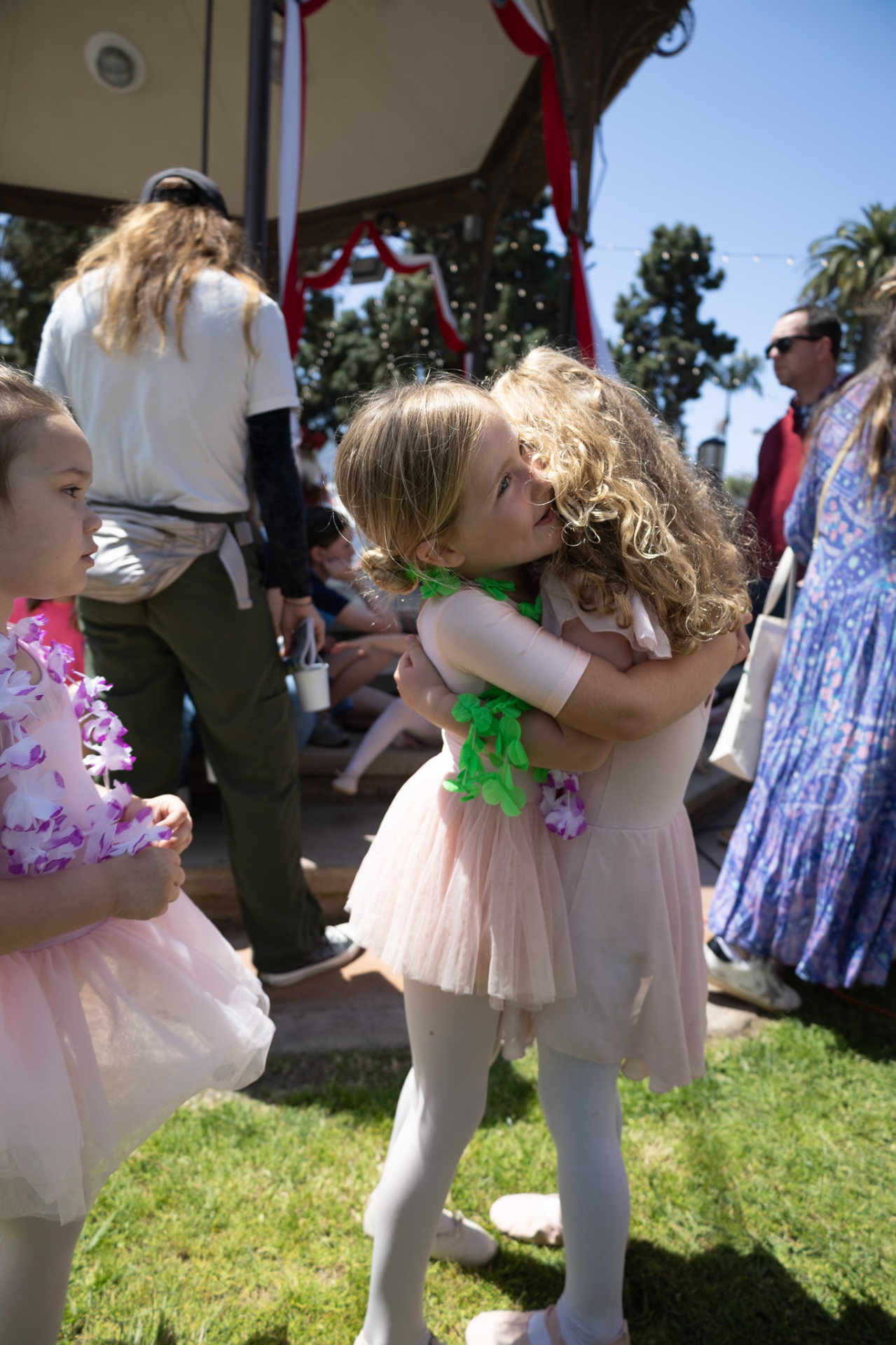 Two young dancers hugging at a studio event